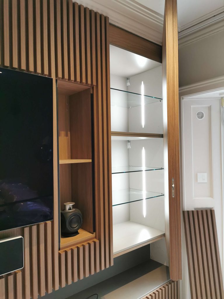 Creative Built in fitted contemporary luxury modern slatted walnut wall panelling with hidden storage design Foxrock Dublin Ireland