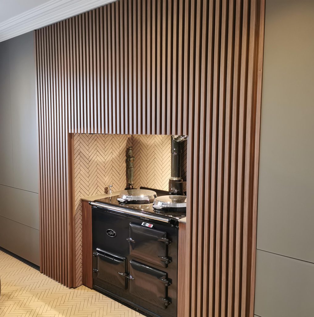 Res Italia Doga Walnut slatted wallpanel with herringbone tiles and black AGA