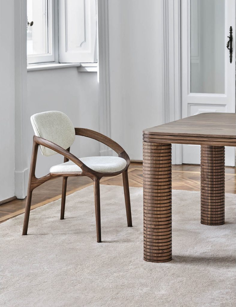 Porada Molly dining chair. Solid walnut organic hand carved frame. Cream texture rich upholstery seat and back. Luxe dining chairs at best furniture store north Dublin